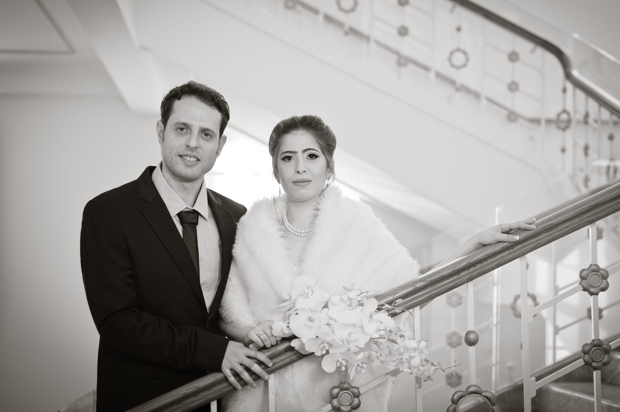 A classic 20's glamour style of the bride and groom featuring the art decor grand stair case captured as a fine art manifestation by Arnold Szmerling during an exclusive collaboration with the King David Jerusalem for the Visual Life Collection.