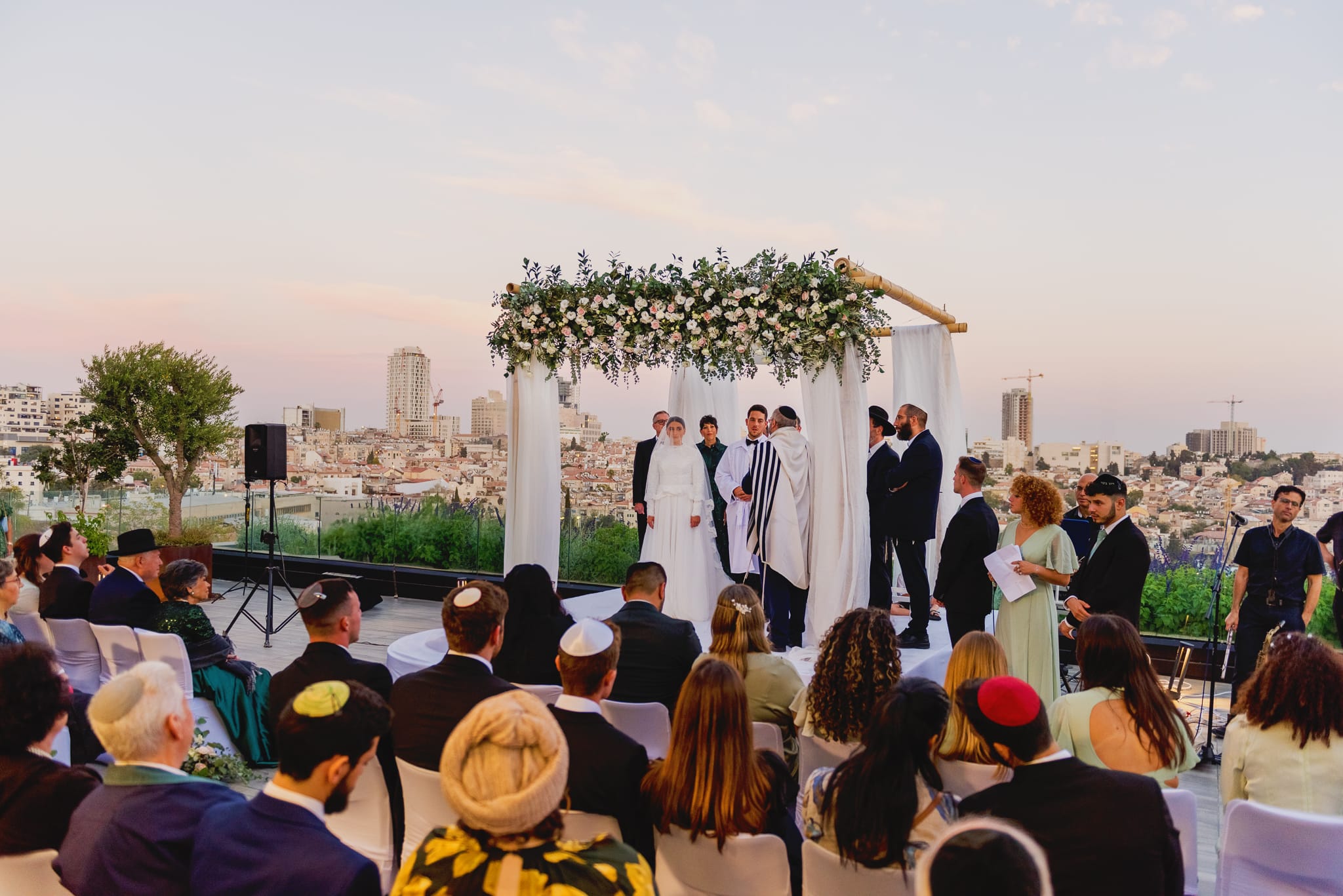 An emotionally captured wide chuppah view at a  luxury Orthodox wedding in Jerusalem, captured as a timeless manifestation by Arnold Szmerling for the Visual Life Collection.