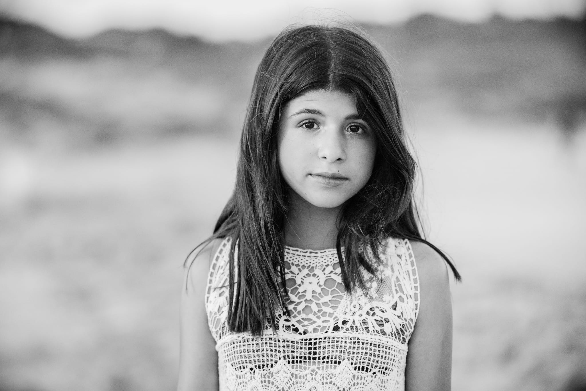Serene black-and-white beach portrait of a twelve-year-old girl during her Bat Mitzvah – natural light moment by Arnold Szmerling