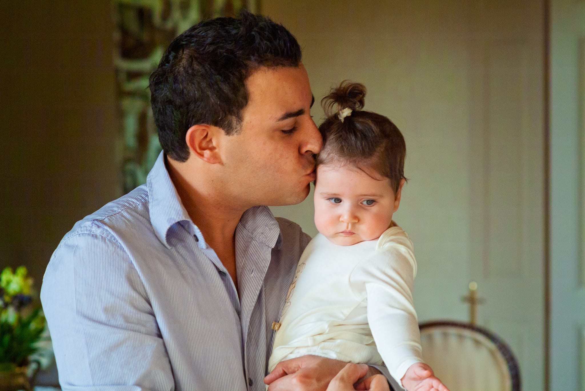 A father tenderly kissing his baby daughter on the forehead — Arnold Szmerling Visual Legacy Artist