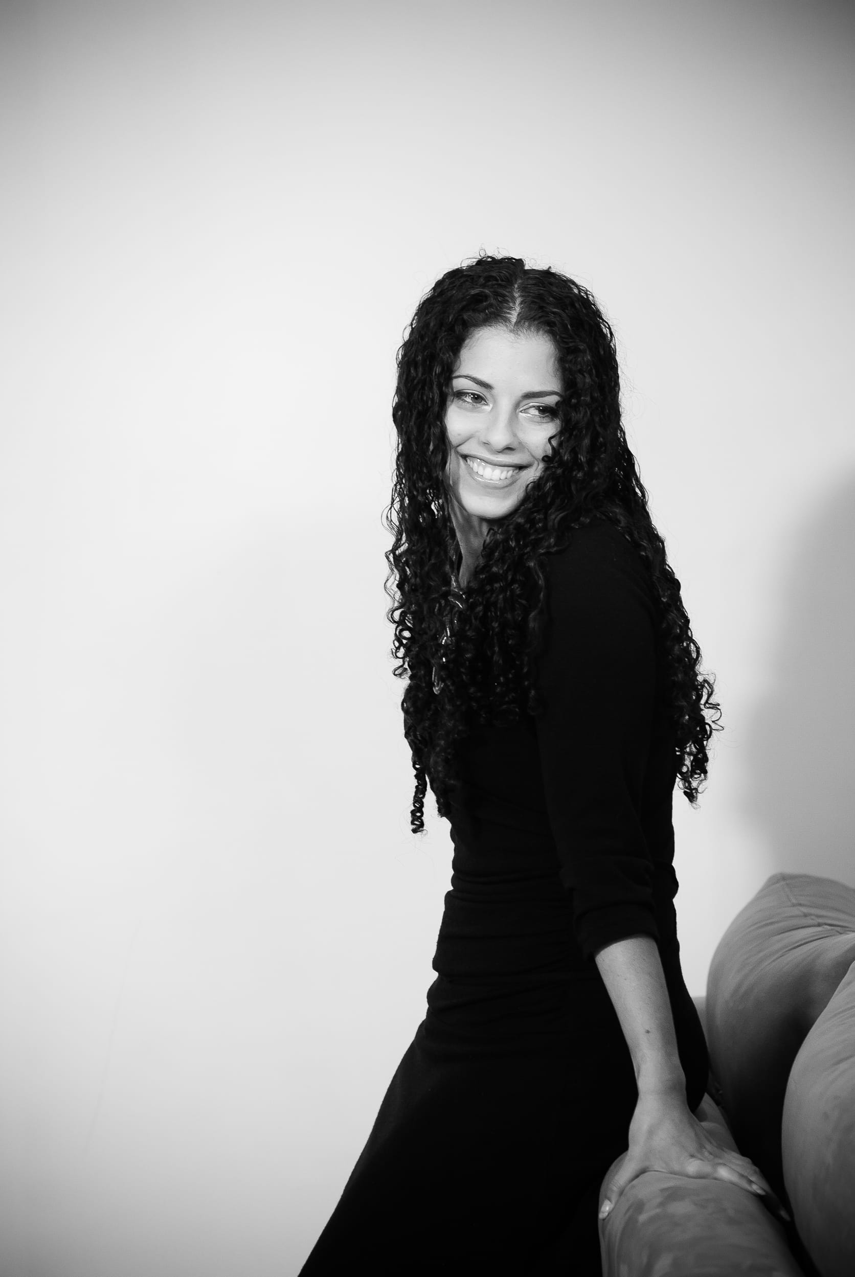 Graceful black-and-white portrait of a young woman at home – multi-generational family legacy by Arnold Szmerling