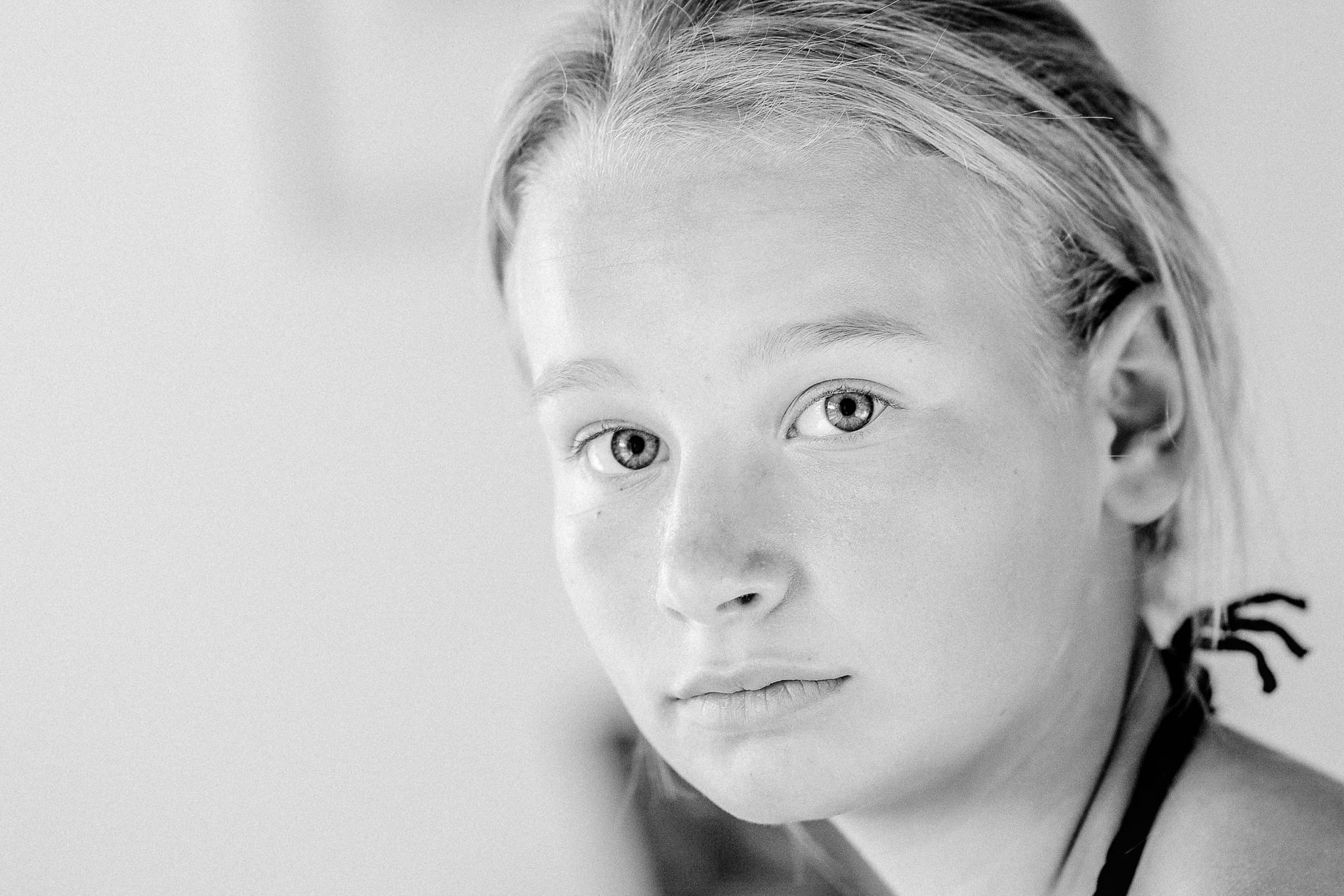 Extreme close-up black-and-white portrait of a twelve-year-old girl in Melbourne – soulful natural-light study by Arnold Szmerling