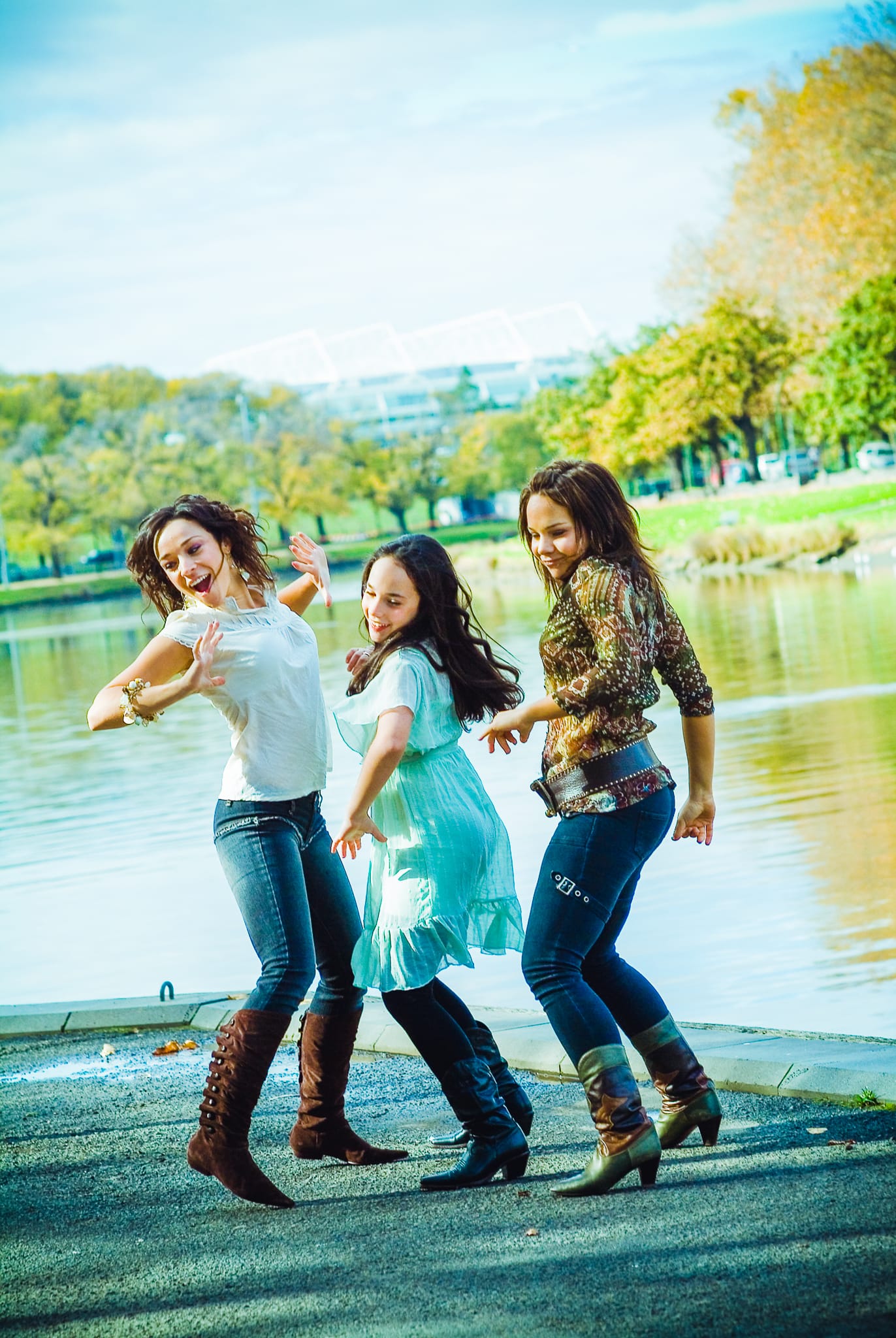 Three young women dancing joyfully by the Yarra River Melbourne in autumn — Arnold Szmerling Visual Legacy Artist